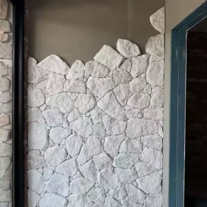 White random stone wall cladding, white crazy‑paving stone installed on interior accent wall